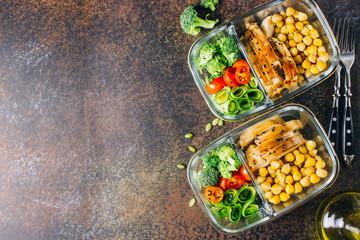 Healthy meal prep containers chicken and fresh vegetables.