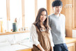© taka - young asian couple in kitchen