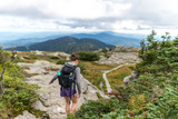 Fototapeta Nowy Jork - female hiker finds her footing hiking along Mount Mansfield in Vermont