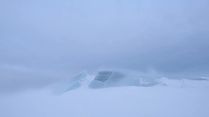 Wall Mural - a snowstorm on the surface of the frozen sea, the wind carries snowflakes through the ice floe.