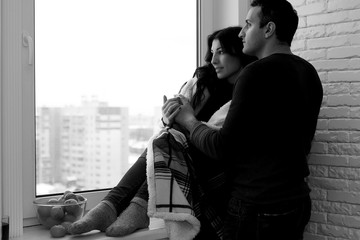 Couple in front of a window