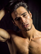 © theartofphoto - Handsome muscular shirtless young man standing confident, front view, looking at camera