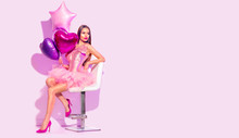 Beauty Fashion Model Party Girl With Heart Shaped Air Balloons Posing, Sitting On Chair. Birthday Party, Valentines Day. Beautiful Young Brunette Woman Full Length Portrait