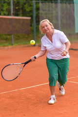 Senior woman playing tennis