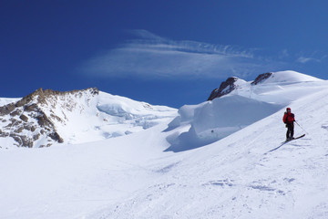 Poster - backcountry skier admires the view of the Monte Rosa mountains and glaciers in the Swiss Alps above Zermatt on a beautiful winter day