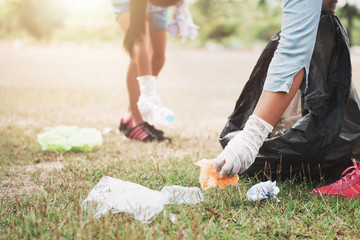 Wall Mural - people picking up garbage and putting it in plastic black bag