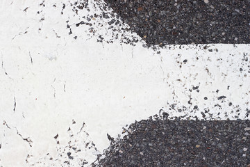 Asphalt pavement sign marking crosswalk white paint wet old surface texture detail