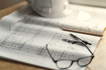 Fototapete - Top view desk work table architect with drawing home plan building and stationary in home office