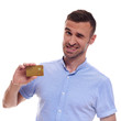 © Elena Kharichkina - Happy smiling young man showing credit card isolated on white background