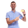 © Elena Kharichkina - Happy smiling young man showing credit card isolated on white background
