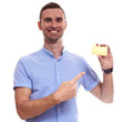 © Elena Kharichkina - Happy smiling young man showing credit card isolated on white background
