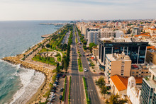 Aerial View Of Molos Promenade Park On Coast Of Limassol City Centre In Cyprus. Bird's Eye View Of The Jetty, Beachfront Walk Path And Palm Trees By The Sea.