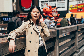 Wall Mural - girl tourist standing near takoyaki restaurant