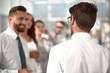 © ASDF - rear view.businessman standing in the office