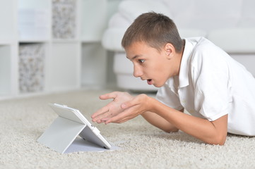 Wall Mural - Portrait of a young boy with the tablet