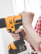 © Voyagerix - Hand holding yellow drill