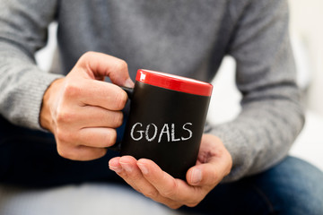 Wall Mural - man with a mug with the word goals