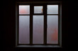 © Mikhail Semenov - a lighted window in the black room of an abandoned house, a clear outline, glass covered with frost,