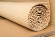 © New Africa - Roll of brown corrugated cardboard, closeup. Recyclable material