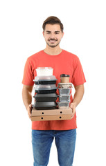 Canvas Print - Young courier with pizza boxes, containers and drinks on white background. Food delivery service