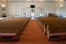 Wide Angle Shot Of Interior Of Empty Church Lit By Faint Sunlight