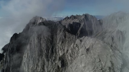 Wall Mural - aerial drone shot flying over mountain ridge of jade dragon national park in yunnan, stark natural s