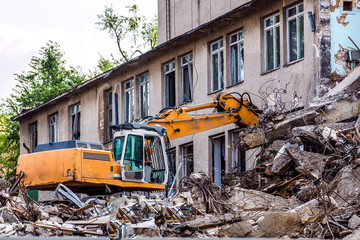 demolition of a building with a hydraulic excavator