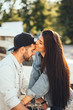© teksomolika - Young, loving parents kiss in the parking near the supermarket.