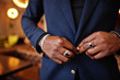 © AS Photo Family - Close up hands of fashionable african american man in suit tied button.