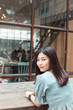 © themorningglory - Portrait of beautiful asian women sitting on wood table in art coffee shop