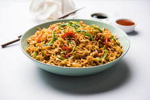 Schezwan Veg Noodles Is A Spicy And Tasty Stir Fried Flat Hakka Noodles With Sauce And Veggies. Served With Chopsticks. Selective Focus