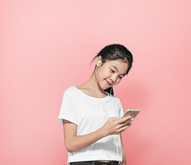 Wall Mural -  young asian teen girl in headphones listening to music