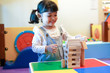 © Asada - Asian kid playing with wooden blocks. Kindergarten educational games.