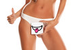 © vladimirfloyd - Woman with panties cowers her vagina with smile drawn on sheet of paper on white background and showing thumbs up