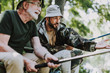 © Yakobchuk Olena - Positive elderly man and his son fishing together