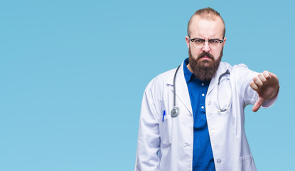 Canvas Print - Young caucasian doctor man wearing medical white coat over isolated background looking unhappy and angry showing rejection and negative with thumbs down gesture. Bad expression.