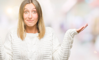 Poster - Young beautiful woman wearing winter sweater over isolated background clueless and confused expression with arms and hands raised. Doubt concept.