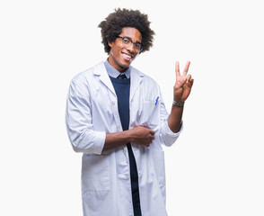 Wall Mural - afro american doctor scientist man over isolated background smiling with happy face winking at the c