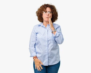 Beautiful middle ager senior businees woman wearing glasses over isolated background touching mouth with hand with painful expression because of toothache or dental illness on teeth. Dentist concept.