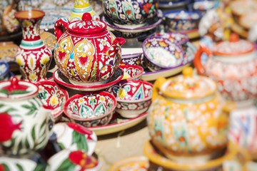 Wall Mural - Plates and pots on a street market in Uzbekistan. Selective Focus.