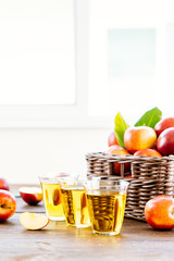 Wall Mural - Apples juice in glass with apple in the basket