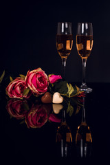 Wall Mural - Two glasses of champagne, roses and two heart shape chocolates