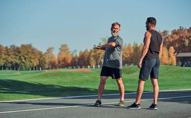  The two men doing exercise outdoor