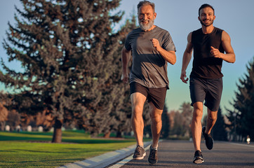 Wall Mural - The father and son running on the road