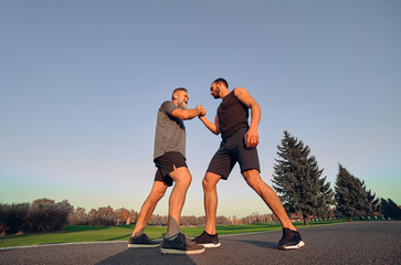 Sticker - The two opponents holding hands in the park