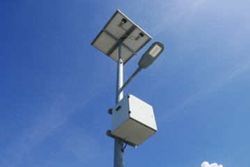 Wall Mural - Close up view of LED street light with solar cell on clear blue sky background with clouds.