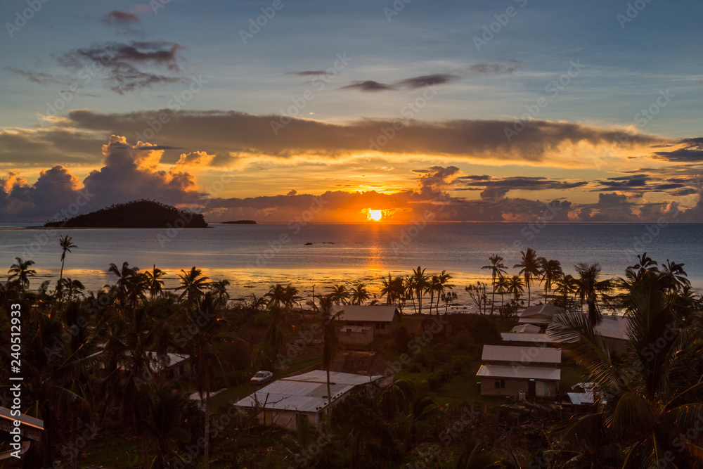 Early morning and sunrise over Pacific Ocean in Mata-Utu village, the capital of Wallis and Futuna territory (Wallis-et-Futuna), French overseas island collectivity. Downtown is overgrown with palms - obrazy, fototapety, plakaty 