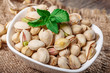 Pistachios in a bowl,selective focus,  on wooden background, top view