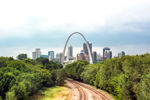 St. Louis, The "Gateway To The West." Skyline Seen Over Trees With Train Tracks Leading Into The City