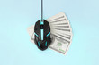Black computer mouse on many hundred dollar bills